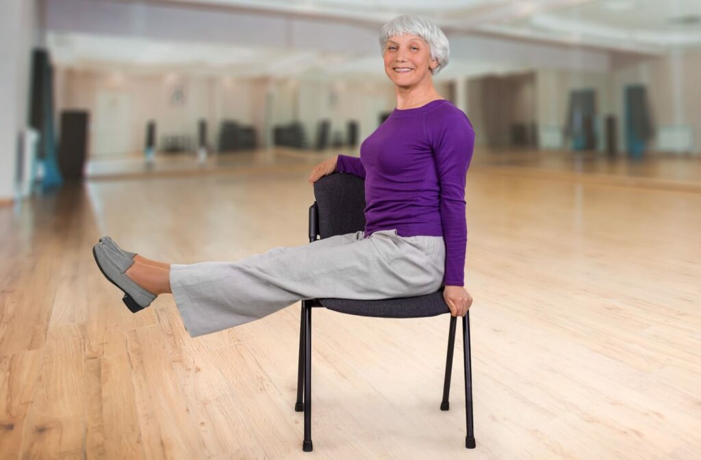 a senior woman performing chair yoga