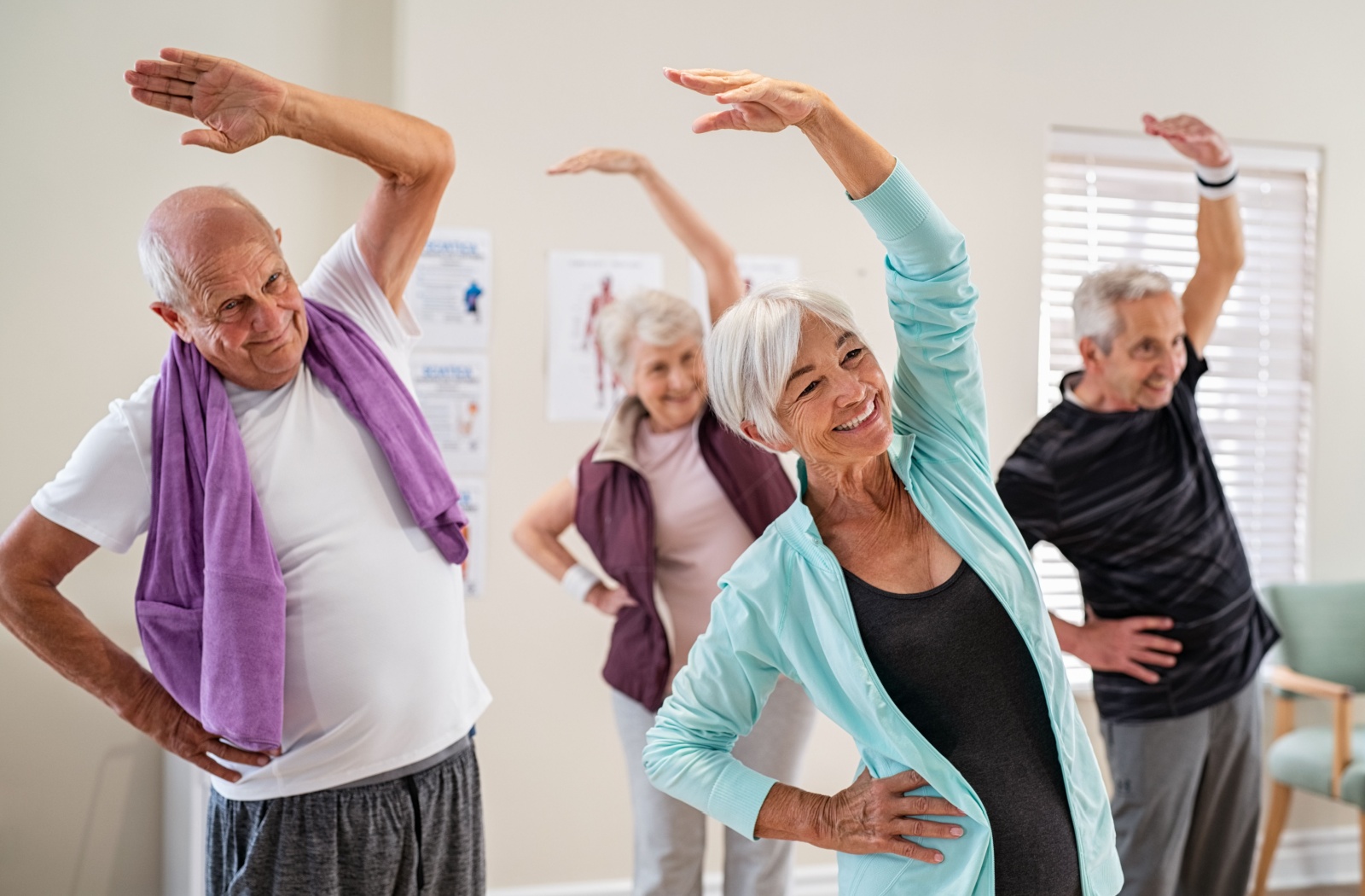 A group of happy seniors enjoying a community fitness class together.