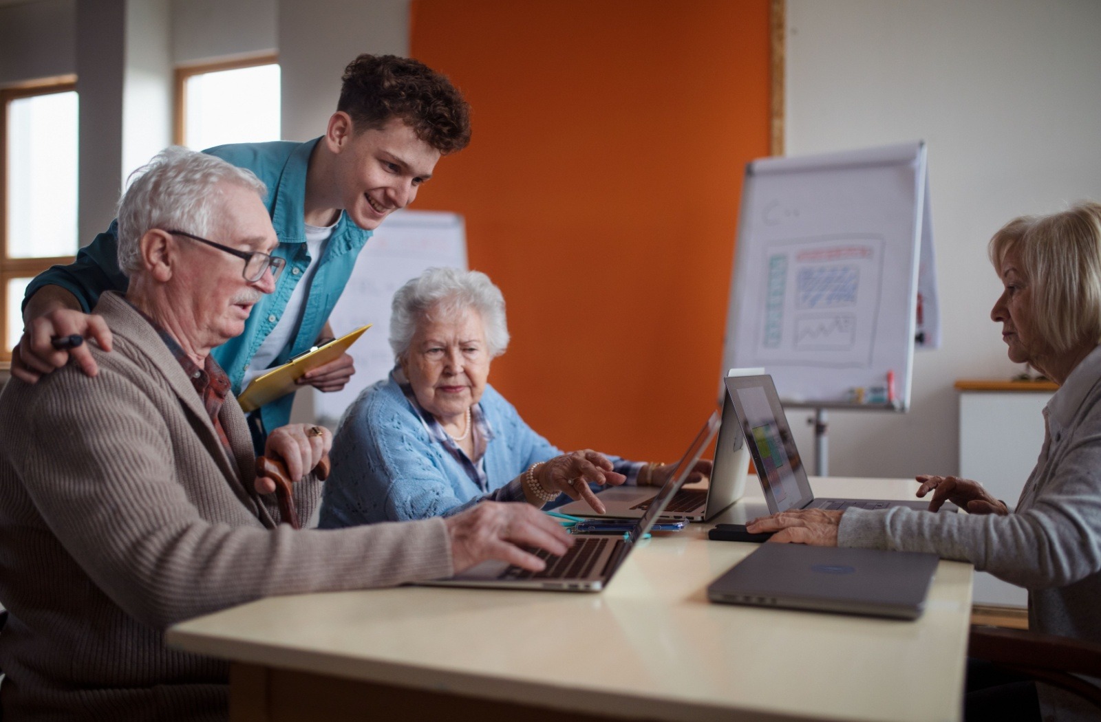 A group of seniors take a computer learning class together.